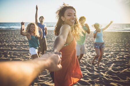 Group of friends having fun on the seashoreの写真素材