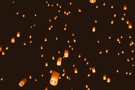 Loy krathong festival, thai new year party with floating lanterns release in the night sky