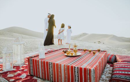 Happy family spending a wonderful day in the desert making a picnicの写真素材