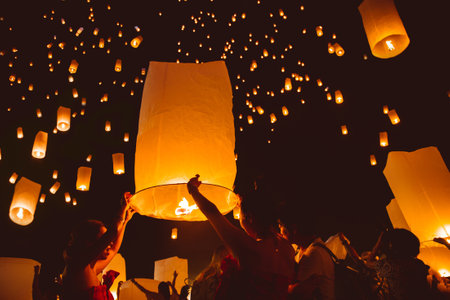 Loy krathong festival, thai new year party with floating lanterns release in the night skyのeditorial素材