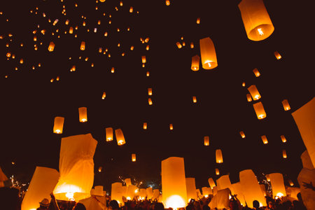 Loy krathong festival, thai new year party with floating lanterns release in the night skyのeditorial素材
