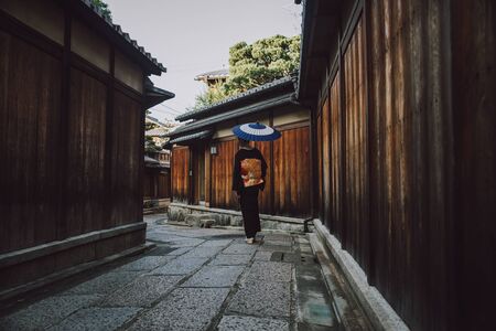 Beautiful japanese senior woman walking in the village. Typical japanese traditional lifestyleの写真素材