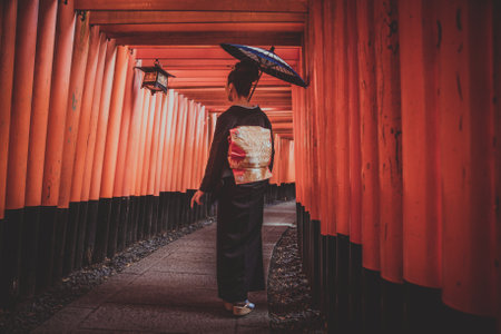 Beautiful japanese senior woman walking in the fushimi inari shrine in Kyotoのeditorial素材