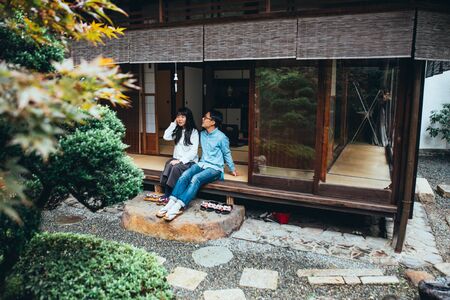 Young japanese couple spending time in their houseの写真素材