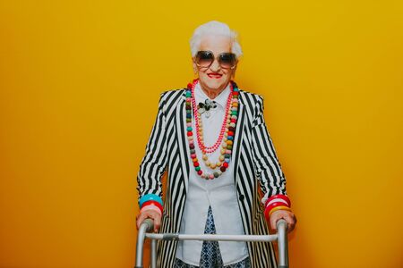 Funny grandmother portraits. Senior old woman dressing elegant for a special event. granny fashion model on colored backgroundsの写真素材
