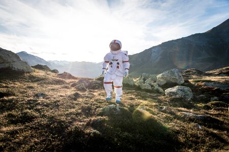 Astronaut exploring a new planet. Searching for a new home for humanity. Concept about science and natureの写真素材
