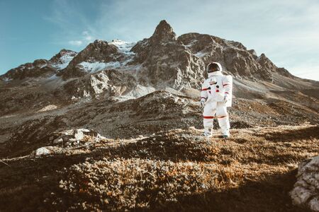 Astronaut exploring a new planet. Searching for a new home for humanity. Concept about science and natureの写真素材