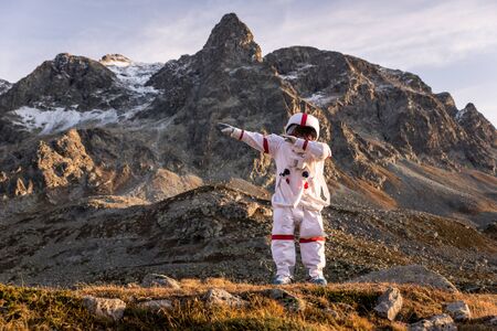 Astronaut exploring a new planet. Searching for a new home for humanity. Concept about science and natureの写真素材