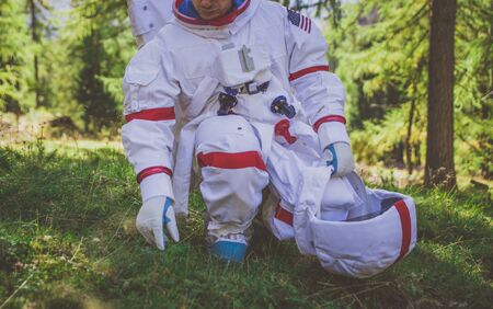 Astronaut exploring a new planet. Searching for a new home for humanity. Concept about science and...
