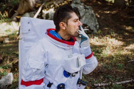 Astronaut exploring a new planet. Searching for a new home for humanity. Concept about science and...