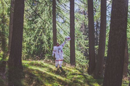 Astronaut exploring a new planet. Searching for a new home for humanity. Concept about science and nature.の写真素材