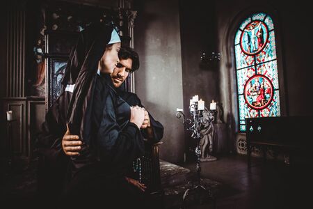Nun and priest praying and spending time in the monastery