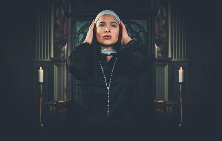 Nun praying in a monastery