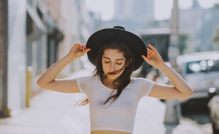 Beautiful young woman walking in New york on a sunny dayの写真素材