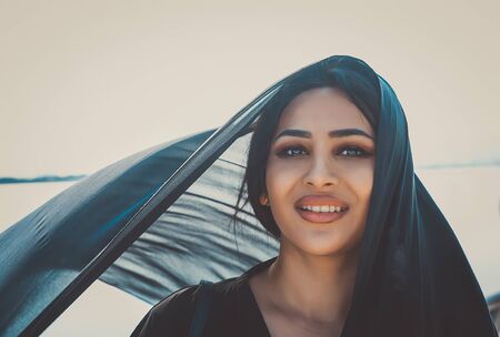 Beautiful woman in Dubai wearing abaya traditional female dressの写真素材