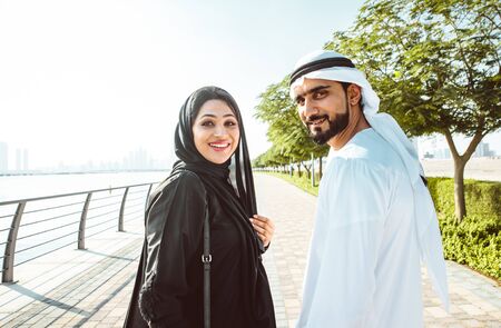 Happy couple walking in Dubai. Man and woman going out for shopping. Concept about relationship in...