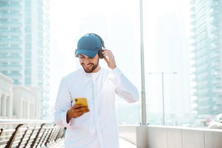 Beautiful middle eastern man wearing kandora traditional outfit in Dubai. Portraits in the emiratesの写真素材