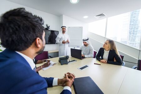 Multiracial group of business people having a meeting in a office - Teamwork in the office, business meeting in the UAEの写真素材