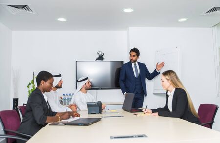Multiracial group of business people having a meeting in a office - Teamwork in the office, business meeting in the UAEの写真素材