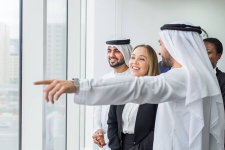 Multiracial group of business people having a meeting in a office - Teamwork in the office, business meeting in the UAEの写真素材