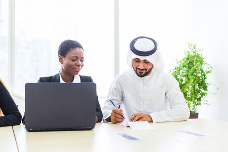 Multiracial group of business people having a meeting in a office - Teamwork in the office, business meeting in the UAEの写真素材