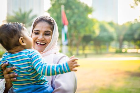 Middle eastern family with traditional dress having fun outdoors - Modern islamic mom and son in Dubaiの写真素材