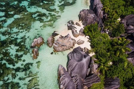 Beautiful beach with white sand on a tropical island in the Seychelles - The famous beach of Anse d'Argent in La Digueの写真素材