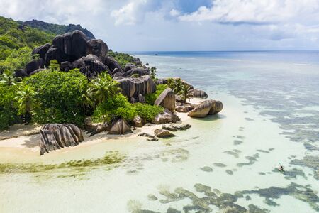 Beautiful beach with white sand on a tropical island in the Seychelles - The famous beach of Anse d'Argent in La Digueの写真素材