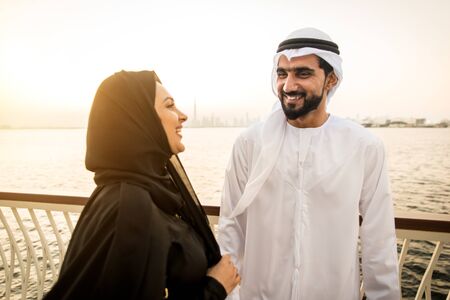 Beautiful middle eastern couple dating outdoors in Dubai - Married pair meeting outdoors and having...