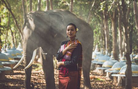 Beautiful thai woman spending time with the elephant in the jungleの写真素材