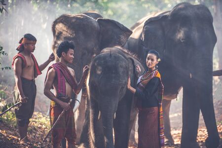 Group of thai shepherds in the jungle with  elephants. Historic lifestyle moments from thailand cultureの写真素材