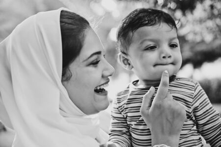 Happy lifestyle moments. Mom and his baby enjoying time in Dubai outdoor in a park.