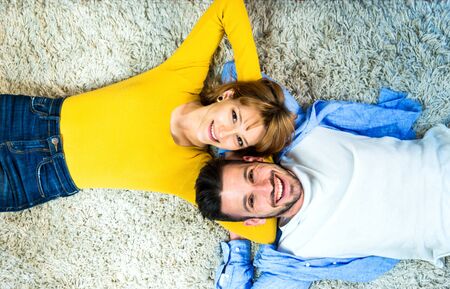 Two young adults at home - beautiful couple of lovers having funの写真素材