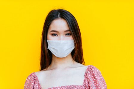 asian girl going out after quarantine during coronavirus period. Young woman outdoor with safety masksの写真素材
