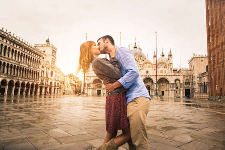 Beatiful young couple having fun while visiting Venice - Tourists travelling in Italy and sightseeing the most relevant landmarks of Venezia - Concepts about lifestyle, travel, tourismの写真素材