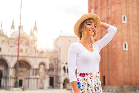 Beatiful young girl having fun while visiting Venice - Tourist travelling in Italy and sightseeing the most relevant landmarks of Venezia - Concepts about lifestyle, travel, tourismの写真素材