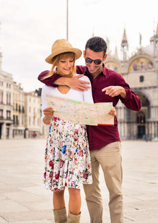Beatiful young couple having fun while visiting Venice - Tourists travelling in Italy and sightseeing the most relevant landmarks of Venezia - Concepts about lifestyle, travel, tourismの写真素材