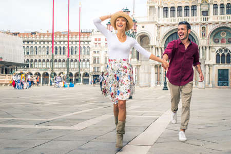 Beatiful young couple having fun while visiting Venice - Tourists travelling in Italy and...