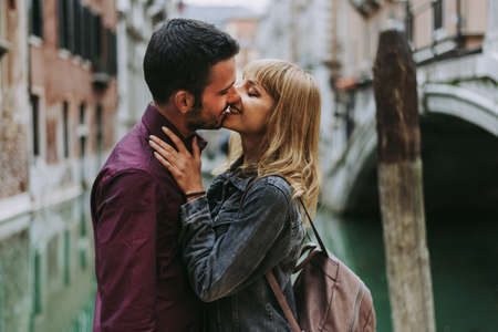 Beatiful young couple having fun while visiting Venice - Tourists travelling in Italy and...