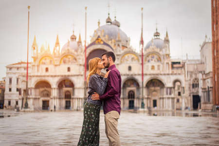 Beatiful young couple having fun while visiting Venice - Tourists travelling in Italy and sightseeing the most relevant landmarks of Venezia - Concepts about lifestyle, travel, tourismの写真素材
