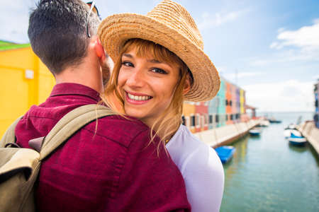 Beautiful young couple having fun while visiting Venice - Tourists traveling in Italy and sightseeing the most relevant landmarks of Venezia - Concepts about lifestyle, travel, tourismの写真素材