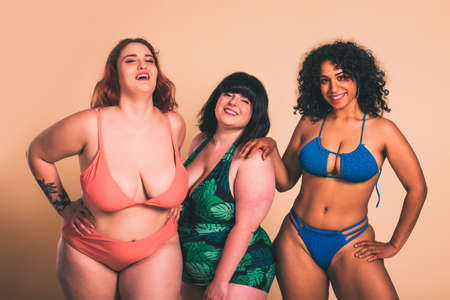 Group of 3 oversize women posing in studio - Beautiful girls accepting body imperfection, beauty shots in studio - Concepts about body acceptance, body positivity and diversityの写真素材