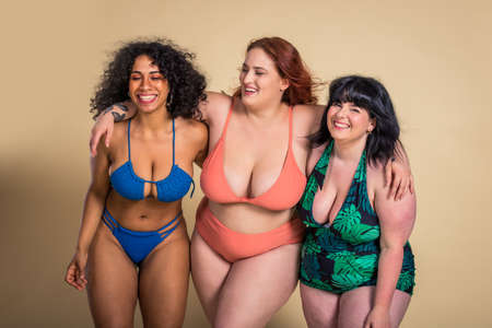 Group of 3 oversize women posing in studio - Beautiful girls accepting body imperfection, beauty shots in studio - Concepts about body acceptance, body positivity and diversityの写真素材