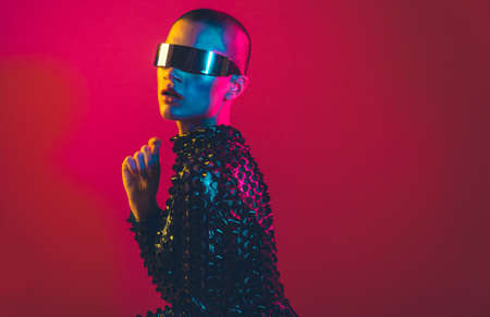 Modern beauty portrait. Young woman with shaved head. Colored gel fashion lookの写真素材
