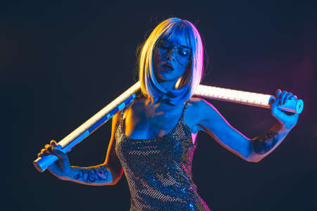 Young woman with gray hair dancing and celebrate. Colored gel portraitsの写真素材