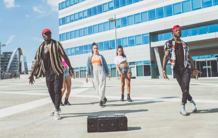 Group of hip hop dancers permorming their dance. Crew making show in an urban placeの写真素材