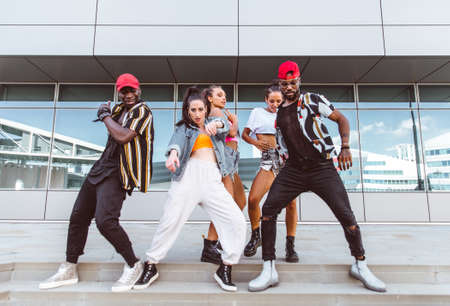 Group of hip hop dancers permorming their dance. Crew making show in an urban place