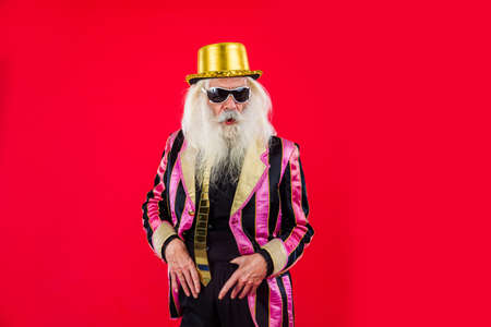 Senior man with eccentric look - 60 years old man having fun, portrait on colored background, concepts about youthful senior people and lifestyleの写真素材