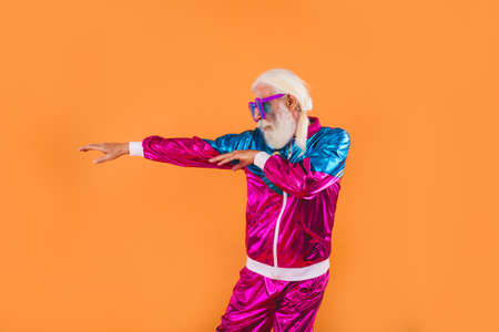 Senior man with eccentric look - 60 years old man having fun, portrait on colored background, concepts about youthful senior people and lifestyleの写真素材