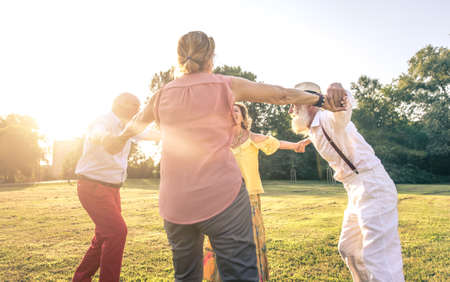 Group of seniors making a picnic at the park and having funの写真素材